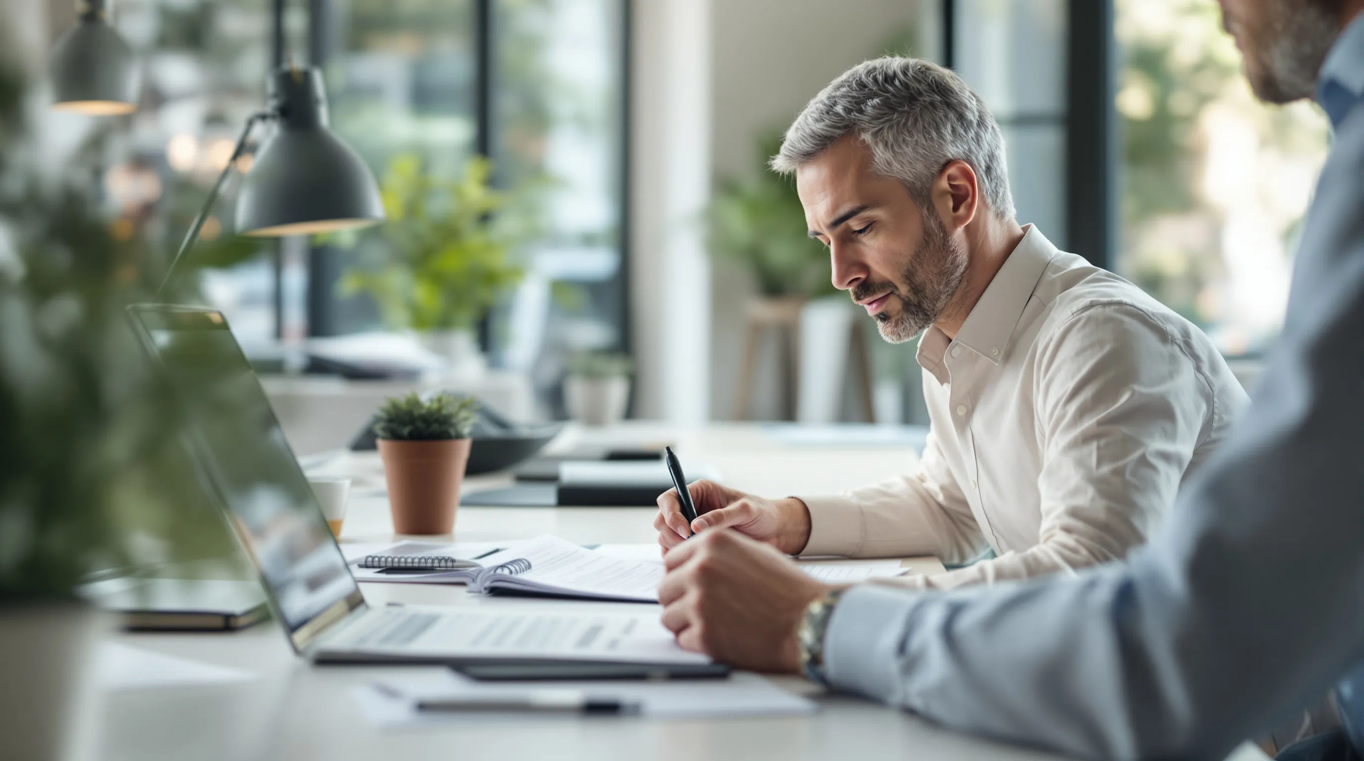 Professional reviewing and organizing documents to build a structured knowledge base for AI customer support agent accuracy